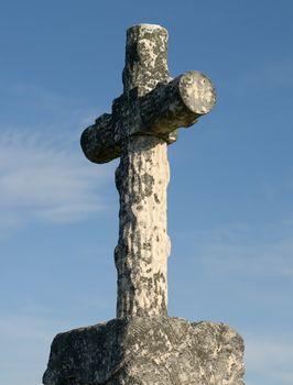 An old cross on top of a grave