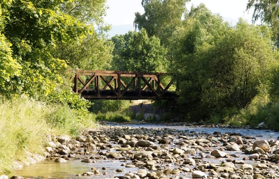 Landscape with Stream and old rusted ralway bridge.