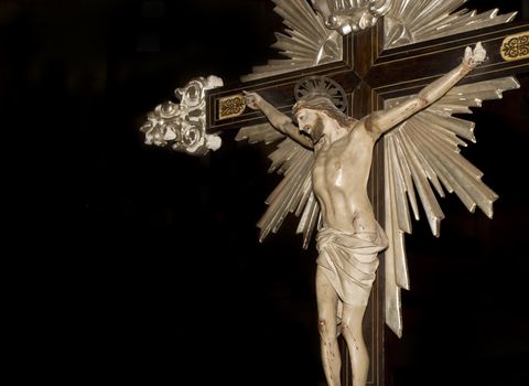 Medieval crucifix with intricate detailing carried during a procession