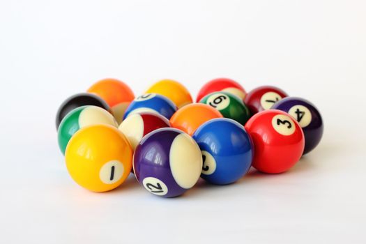 Brightly colored pool or billiard balls on white backgound