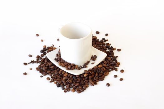 coffee mug, spoon and spilled coffee on white background