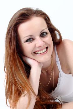 Lying and smiling attractive woman on white background