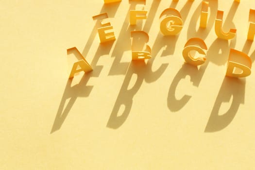 Alphabet made from cutting yellow paper sheet