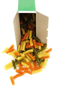uncooked vegetable pasta from the box, white background