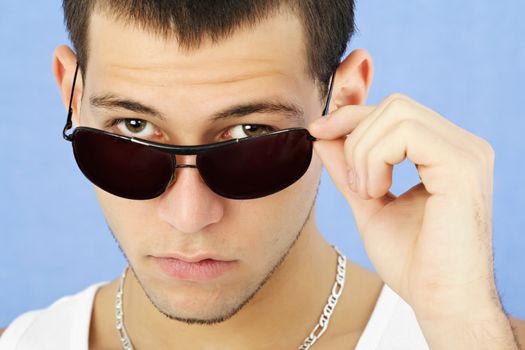 young caucasian man, blue background