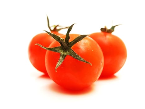 Fresh red tomato toward white background with green grass on top