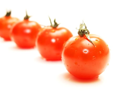 Fresh red tomato toward white background with green grass on top