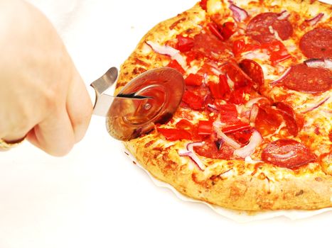 Someone slicing a pizza