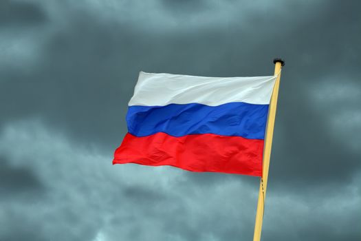 russian national flag on storm-clouds background