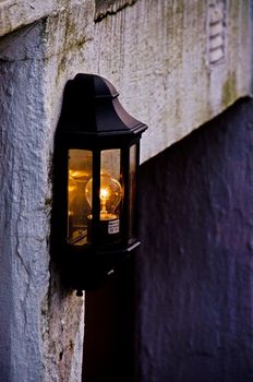A black lamp with soft glow lighten up a cellar entrance