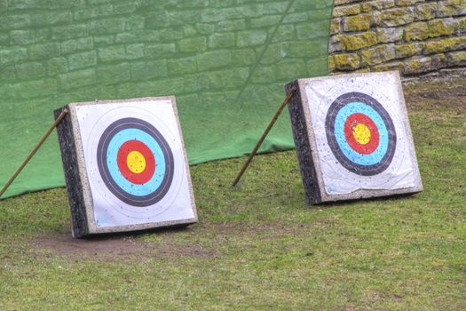 two archery targets and old wall