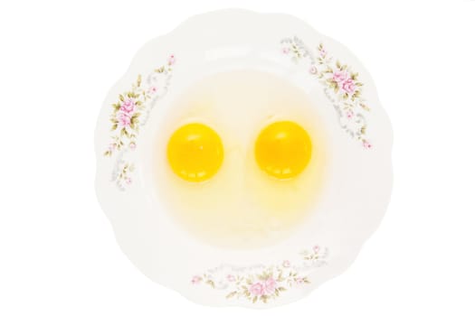 Two row eggs on the white plate
