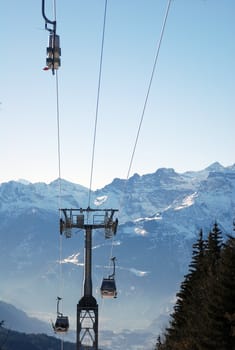 Skiers being transported in telecabine