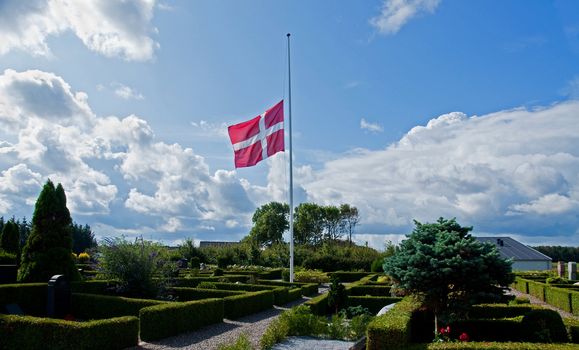 From a danish churchyard with the danish flag at half mast