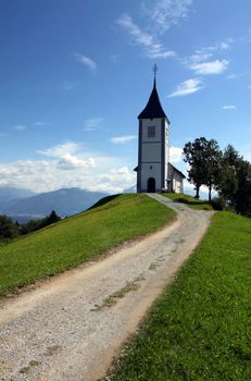 Lonely church on a hill. Stone path to the church