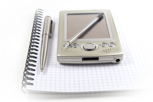 Vignetting image of pen and PDA on spiral notebook