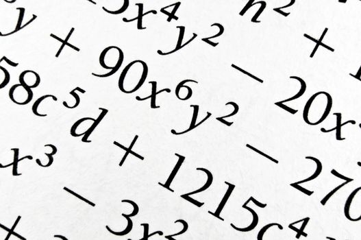 Close up of an old textbook  with algebra formulas. Background of numbers and letters.