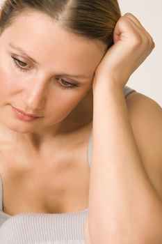 Portrait of young beautiful sad woman on white background