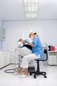 doctor works with patient in the dentist office