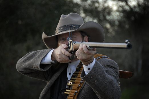 Western style deputy sheriff takes aim with rifle.  Isolated with clipping path.