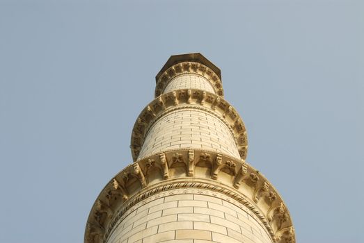 Upward Point of view of one of the minarets on the corner of the Taj Mahal mausoleum in Agra, India.