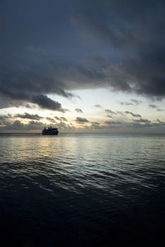 Boat on the cloudy sunset in Micronesia