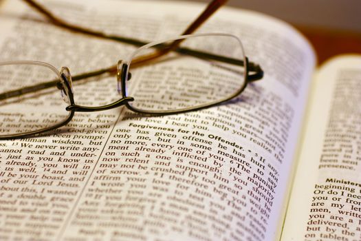 Open Bible with reading glasses