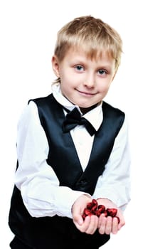 elegant little boy with little red hearts in hands