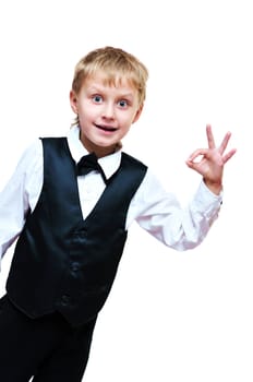 Little smiling elegant saluting boy over the white
