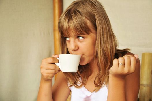 tanned lovely teen girl drinking a tea 
