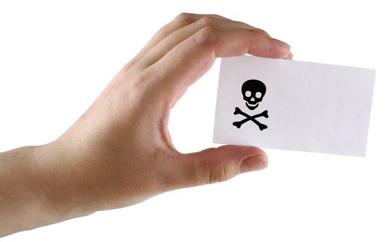 Paper card with the image black jolly Roger in a hand on a white background