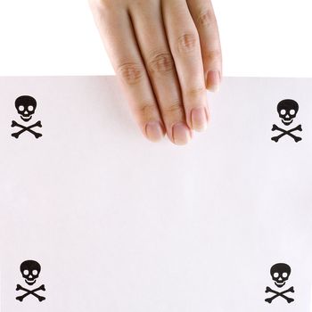 Sheet of paper with the skull and crossbones represented on it in a hand on a white background