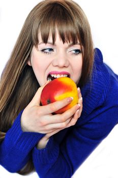 portrait of a beautiful woman eating red apple 
