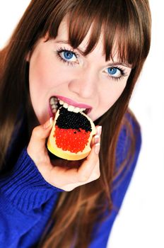  girl eating butterbrad with red and blach caviar 
