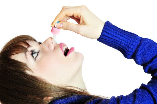 young woman injecting drops into the nose
