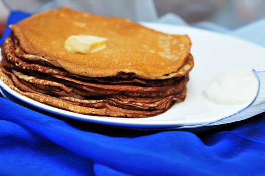  pile of tasty pancakes with butter  in soft focus
