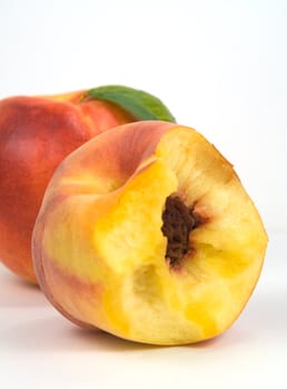 Nectarine and bited peach on white background
