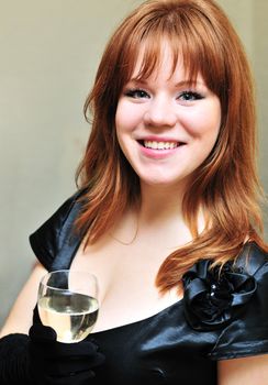 happy redheaded girl with glass of wine