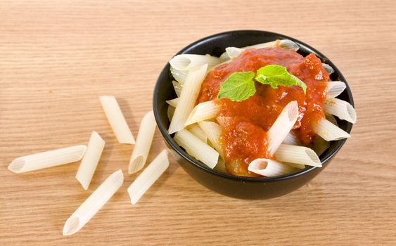 freshly cooked rice penne with hot tomato sauce