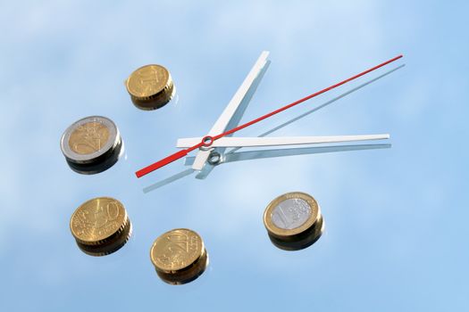 Clock hands and few euro coins lying on mirror background with blue sky and clouds reverberation