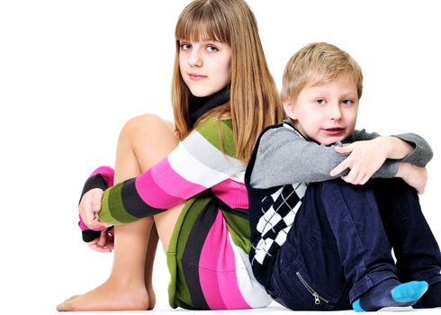 brother and sister sitting on the white background