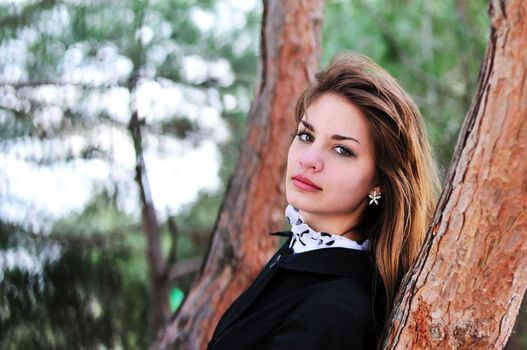 portrait of sweet teen girl near the tree