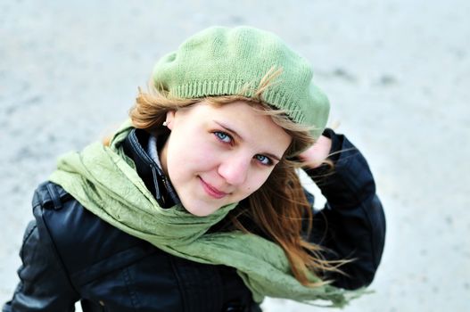 teen girl wearing green beret and scarf