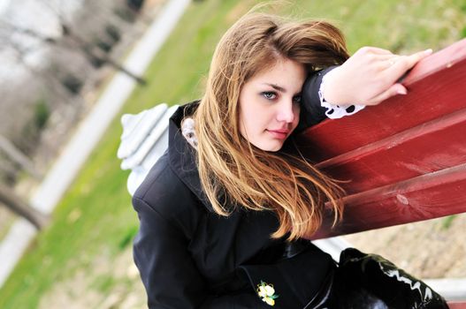 sad girl on the bench in the park