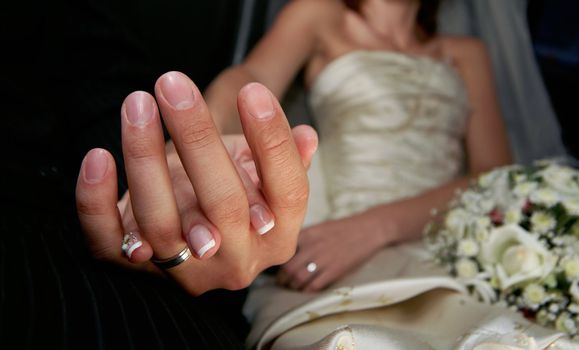 Hand of the groom and the bride with wedding rings
