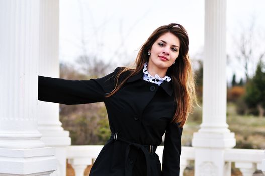   lovely sweet teen girl standing near columns
