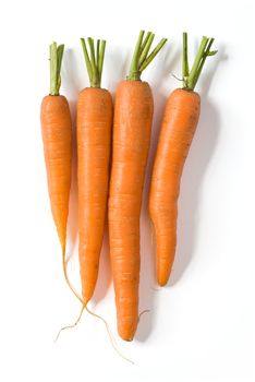 Bunch of fresh carrots isolated on white background. Clipping path included to remove object shadow or replace background.