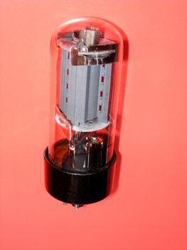 Electronic tube on a red background