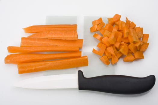 sliced carrots and a knife on a chopping board