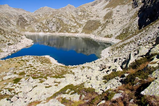 Sunny day, blue sky, mountain lake in Aiguestortes National Park.